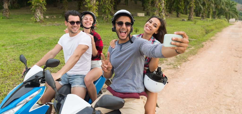 two couples having fun on scooters on Koh Tao