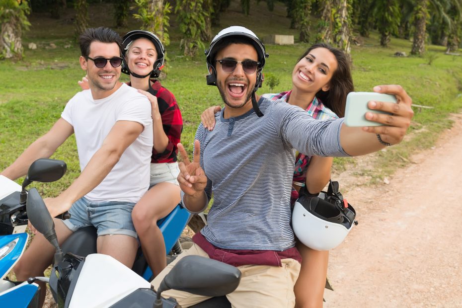 two couples having fun on scooters on Koh Tao