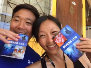 a Couple showing their divers log books